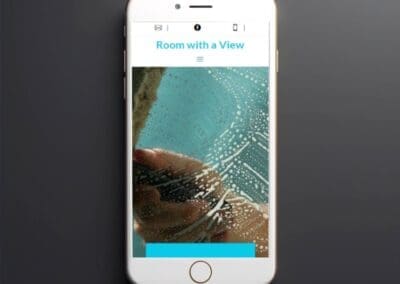 Black smartphone on dark background mockup to showcasing Room with a view website