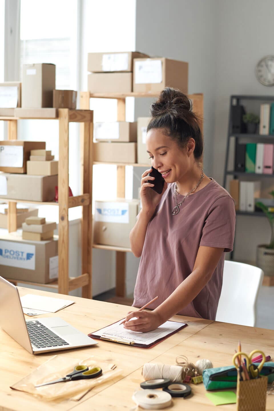 Business owner speaking on a phone while reviewing website accessibility requirements