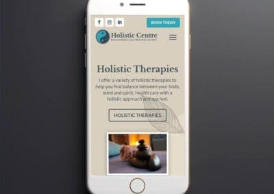 Holistic Centre website Black smartphone on dark background mockup ()