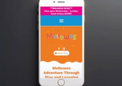 Black smartphone on dark background mockup Mellowes Adventure and Childcare